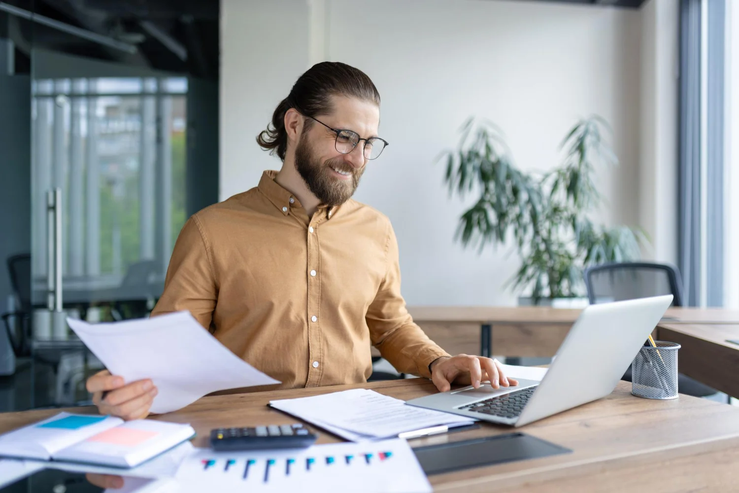 A-man-tracking-expense while smiling