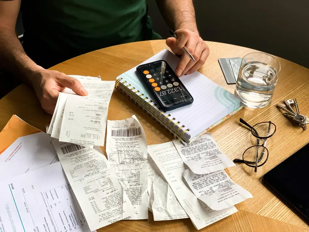 a table filled with receipts and a calculator