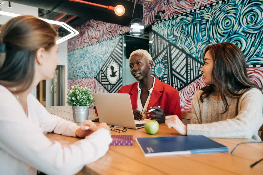 a white woman discussing with her clients